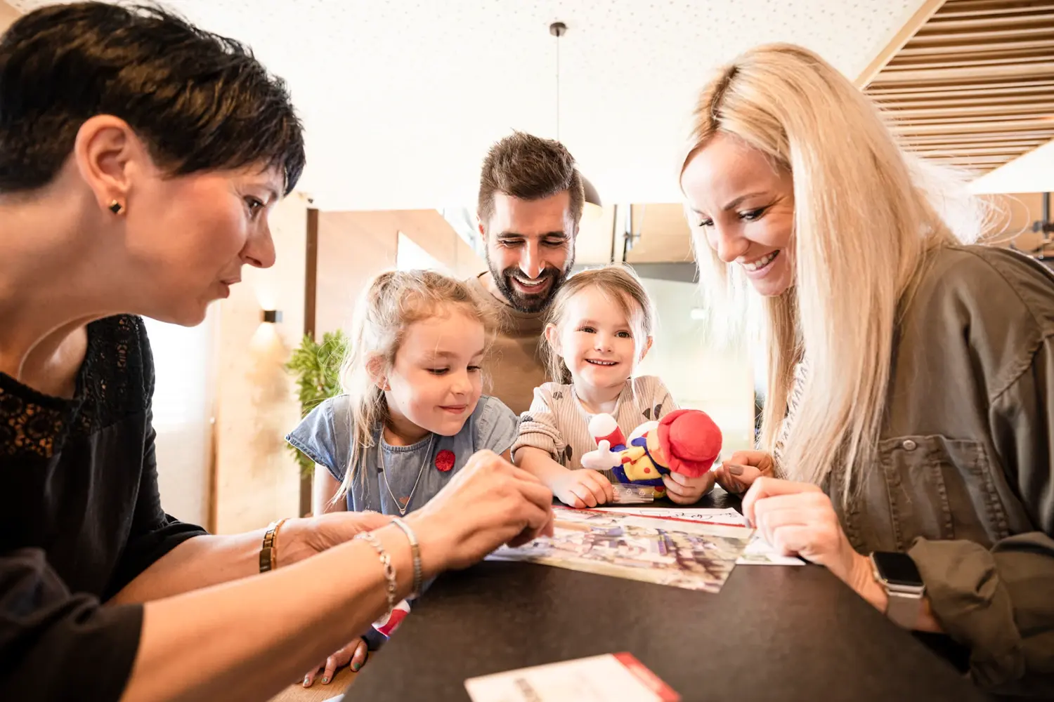 family with two kids is standing at the hotel reception